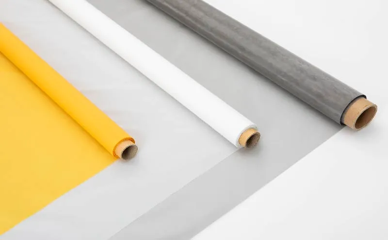 Rolls of screen printing mesh in yellow, white, and gray colors