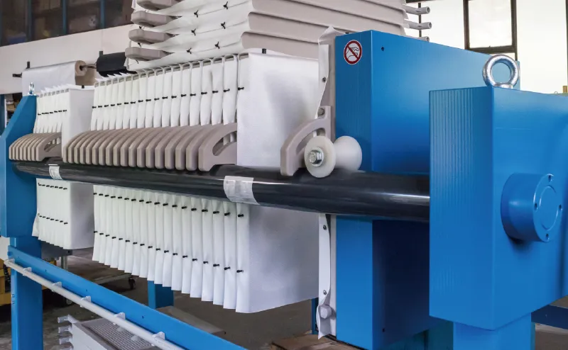 Photo of a filter press device with a blue body and white filtration unit