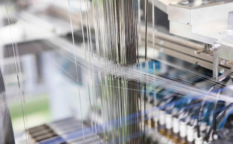 A close-up photo of the part where the thread passes through the loom
